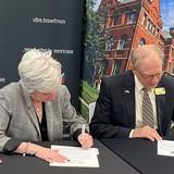 Darrin Good, president of Nebraska Wesleyan University, and Leah Barrett, president of Northeast Community College, sign an articulation agreement Thursday morning at Union 73 on the Northeast campus in Norfolk.